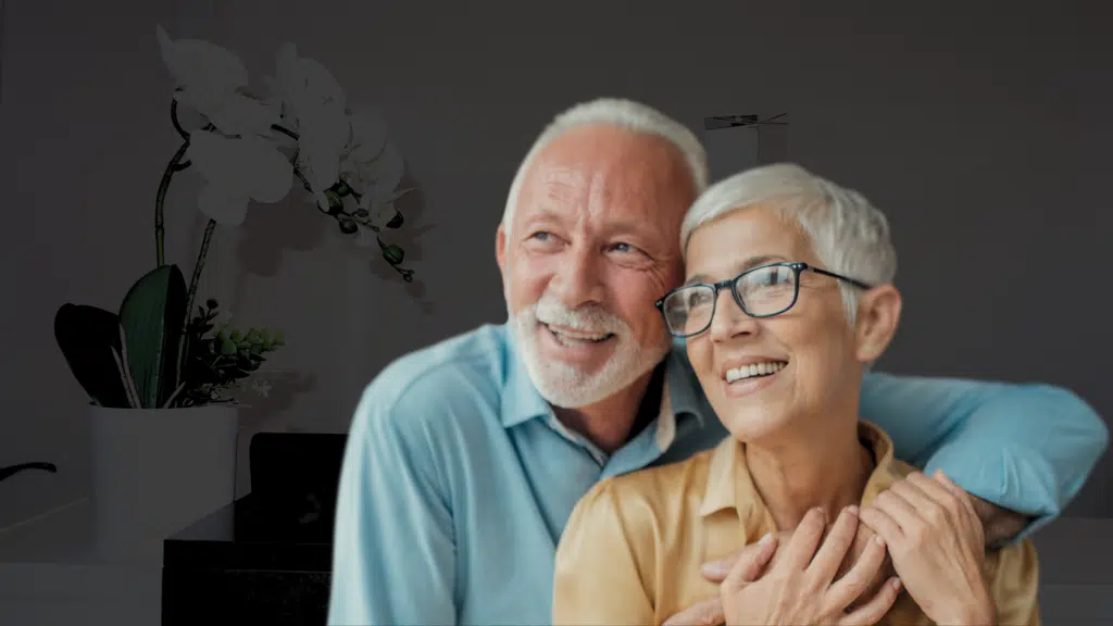 Happy older couple with teeth transformed by dentures in London