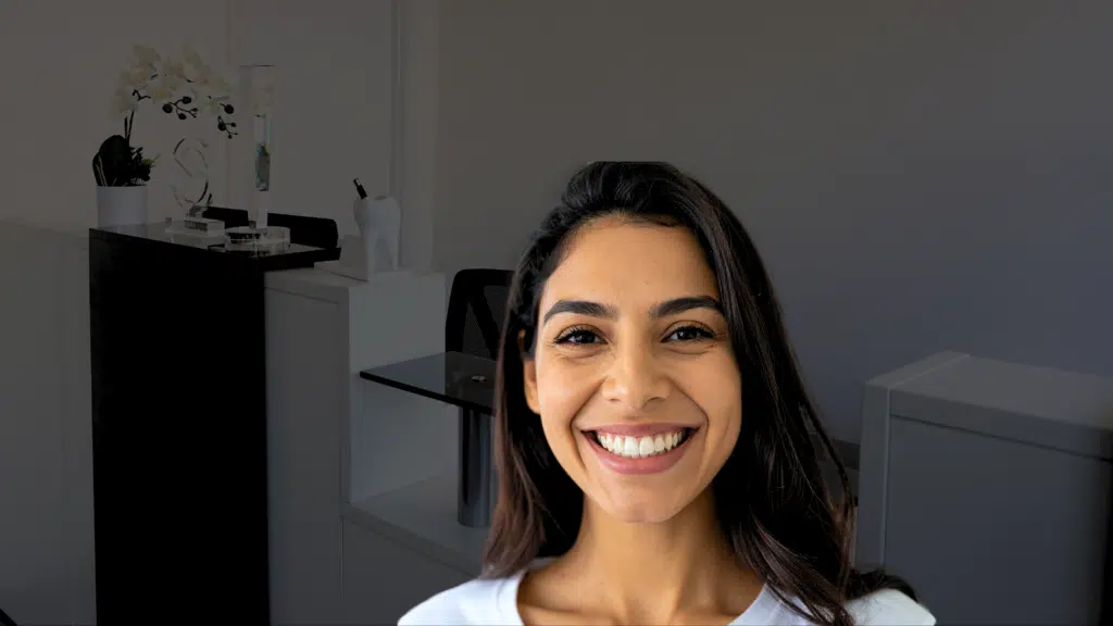Patient smiling after her peg-shaped teeth were corrected through cosmetic bonding treatment in London